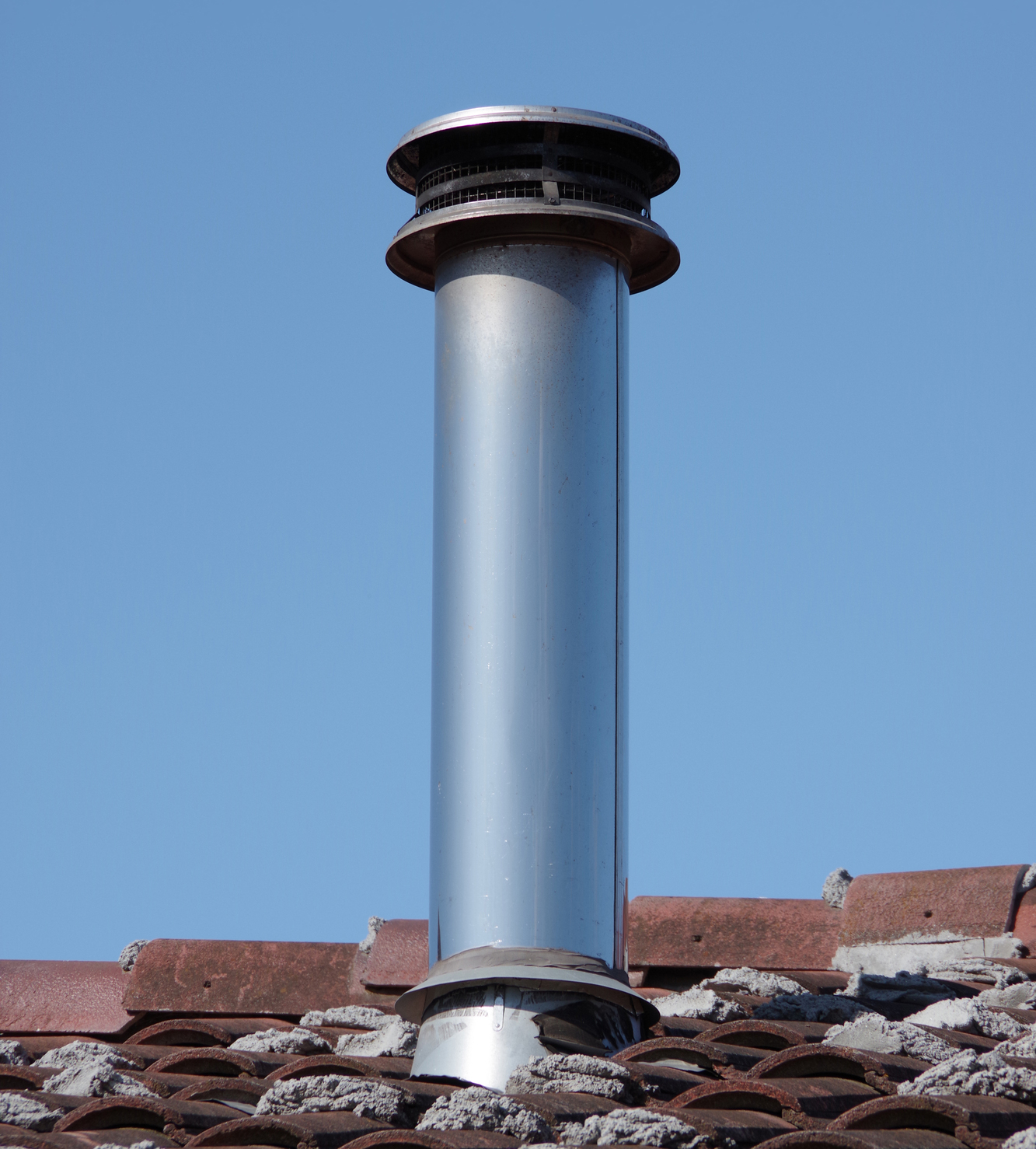 silver steel chimney cap on a roof