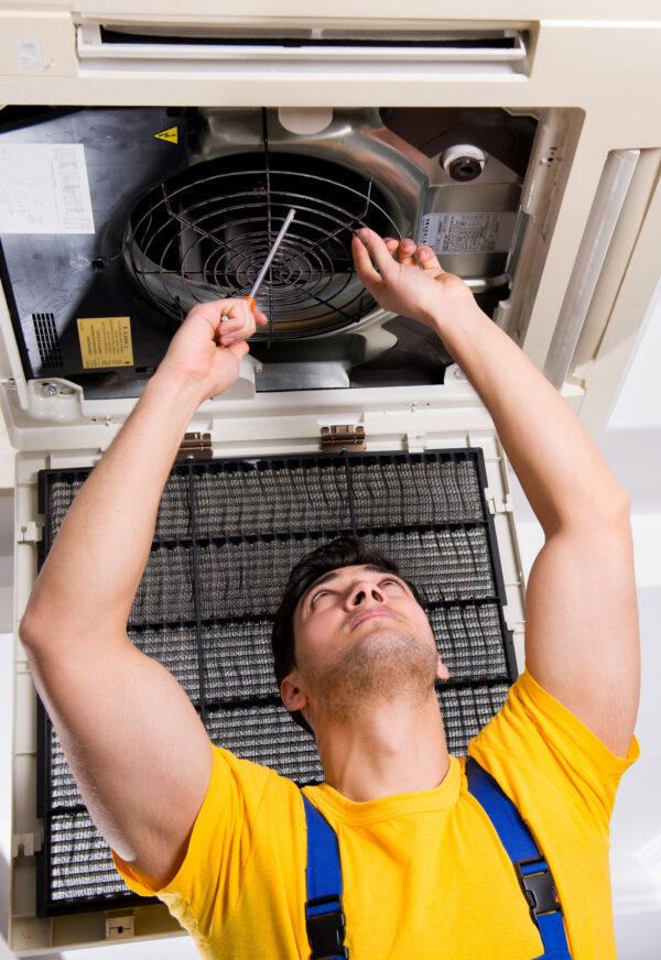 a person repairing the air duct fan